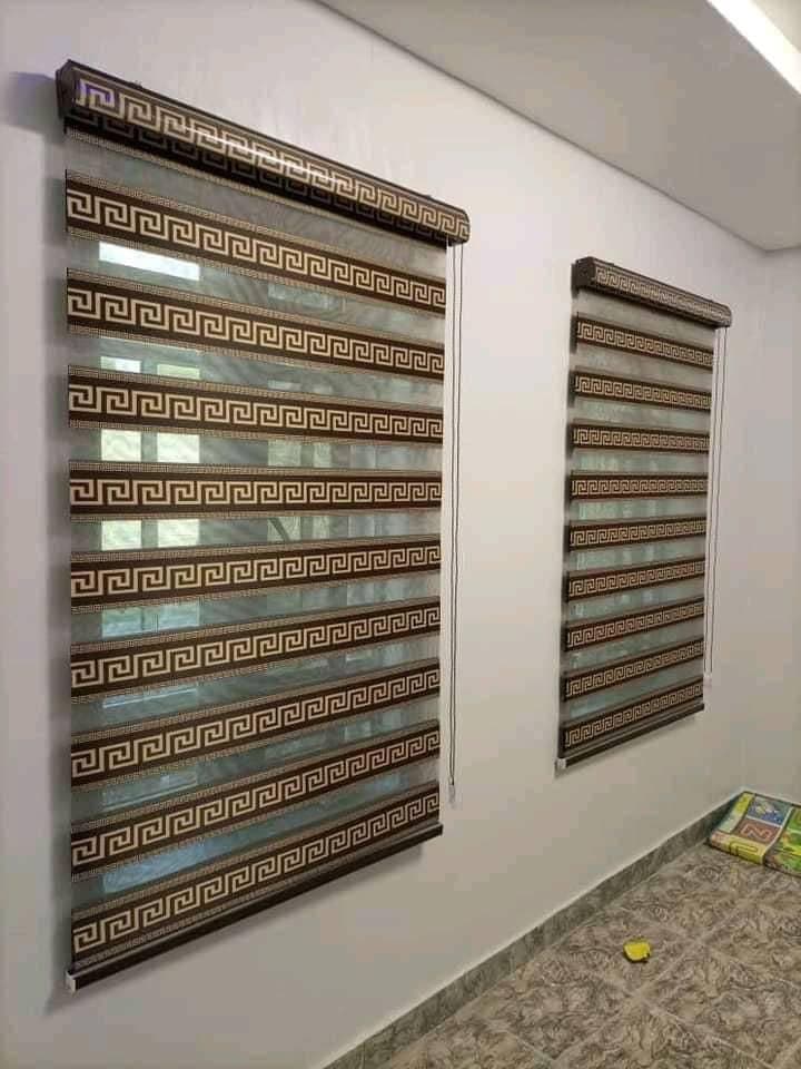 A matched pair of patterned day & night blinds fitted on two windows of the same wall